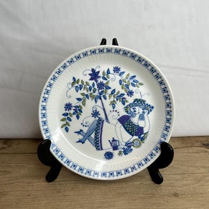 Vintage Figgjo Flint Norway Turi Lotte Design White and Blue Small Side Plate featuring a girl sunbathing in a garden. Good Condition