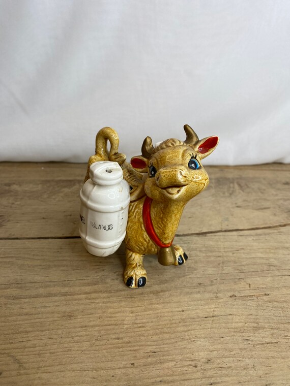 ビンテージの茶色の牛の置物、ベル付き。側面に塩コショウ入れが付い