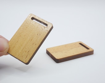 May include: Two small wooden cutting boards with a handle. The boards are light brown with a natural wood grain.
