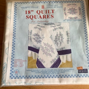 May include: A package of Jack Dempsey Needle Art quilt squares for embroidery. The package features a blue and white design with the text "18" Quilt Squares" and "Forget Me Knots". The package contains six 18 x 18 inch quilt squares.