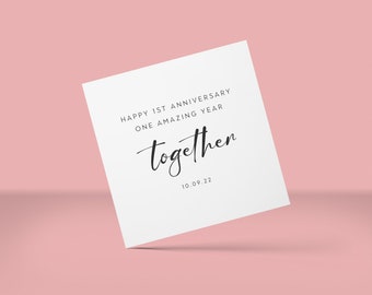 May include: White card with black text that reads "Happy 1st Anniversary One Amazing Year Together 10.09.22".