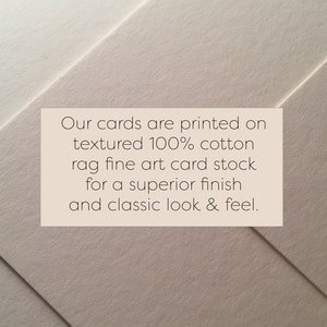 May include: A close-up of textured, off-white card stock with a printed message. The text reads: "Our cards are printed on textured 100% cotton rag fine art card stock for a superior finish and classic look & feel."