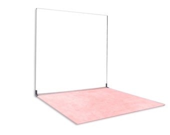 May include: A modern, minimalist display stand featuring a large, rectangular white panel suspended above a pink, textured floor. The stand has a thin, black metal frame and is set against a white background.