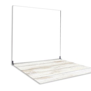 May include: White wood backdrop for photography with a white painted wood floor. The backdrop is a large, flat surface that can be used to create a variety of backgrounds for photos.
