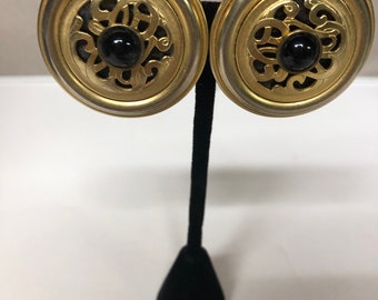 Vintage pair of Gold tone round clip on earrings signed Patti Horn