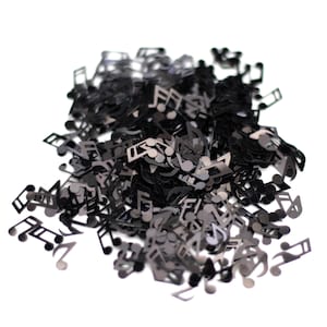 May include: A pile of black musical note confetti. The notes are scattered on a white background.