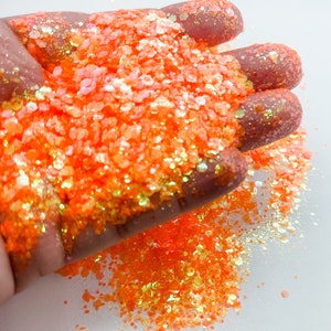 May include: Orange iridescent glitter with a mix of small and large glitter pieces.
