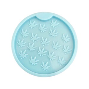 May include: A light blue silicone coaster mold with a design of multiple marijuana leaves.