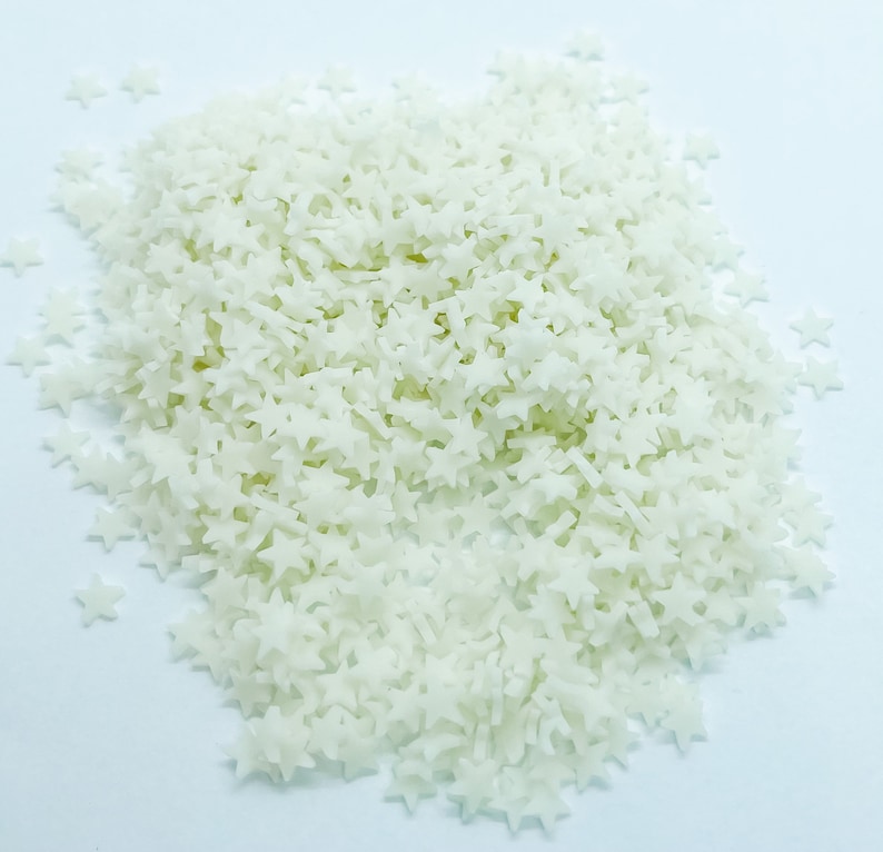 May include: A pile of white star-shaped sprinkles.