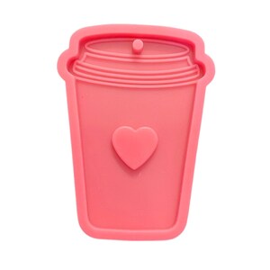 May include: Pink silicone mold shaped like a coffee cup with a heart on the front.