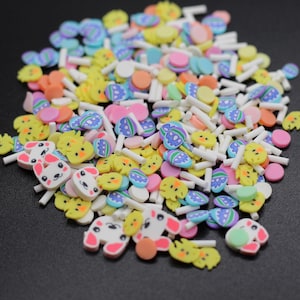 May include: A variety of colorful Easter-themed sprinkles, including chicks, bunnies, eggs, and dots. The sprinkles are made of polymer clay and are perfect for decorating cakes, cupcakes, cookies, and other treats.