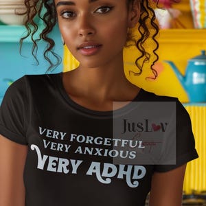 May include: Black t-shirt with white text that reads "Very Forgetful Very Anxious Very ADHD".