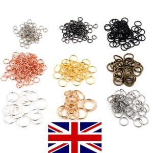 May include: Assortment of jump rings in various colours, including silver, gold, black, rose gold, and bronze. The jump rings are small and perfect for jewellery making.