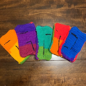 May include: Five knitted phone cases in a rainbow color pattern. The cases are made of a soft, textured yarn and have a simple design. The colors are orange, purple, green, red, and blue.