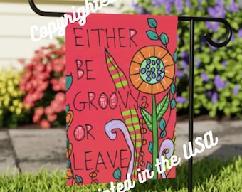 May include: A red garden flag with the text "EITHER BE GROOVY OR LEAVE" in black script. The flag features a colorful floral design with orange, green, and purple accents. The words "Printed in the USA" are also visible.