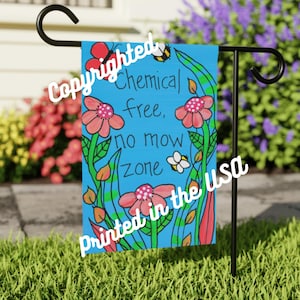 May include: A blue garden flag with the text "Chemical free, no mow zone" surrounded by pink flowers, green leaves, and a bee. The flag is printed in the USA.