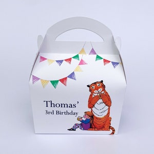 May include: White party favour box with a handle, featuring a cartoon tiger and a girl. The box is decorated with a banner of colourful flags and the text "Thomas' 3rd Birthday".