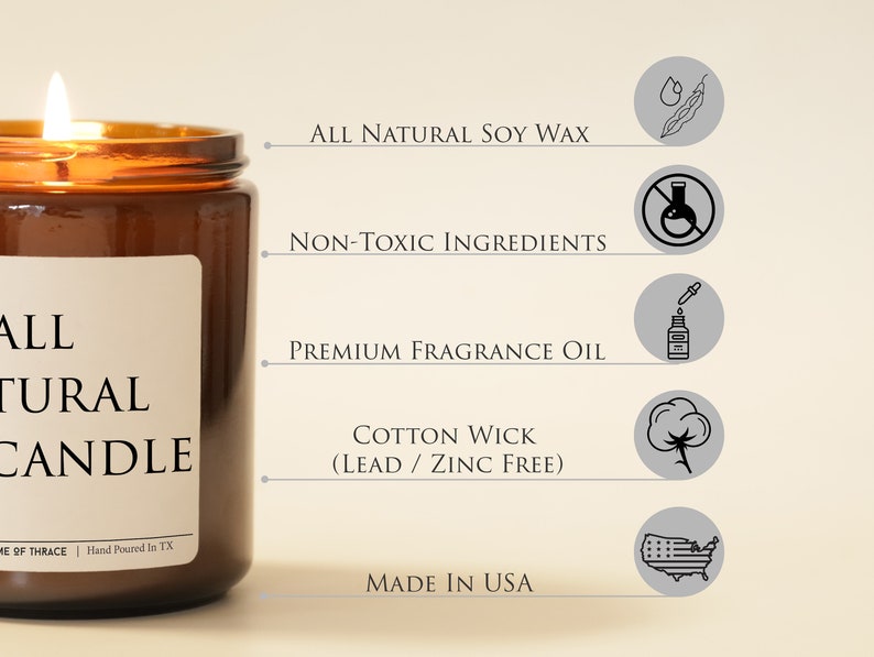 May include: A lit brown glass jar candle with a white label that reads "ALL NATURAL CANDLE". The candle features "ALL NATURAL SOY WAX", "NON-TOXIC INGREDIENTS", "PREMIUM FRAGRANCE OIL", and "COTTON WICK (LEAD / ZINC FREE)". The candle is made in the USA.