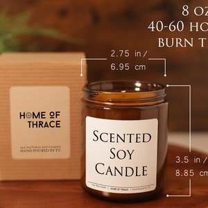 May include: A brown glass jar candle with a white label that reads "Scented Soy Candle." The candle is 3.5 inches (8.85 cm) tall and 2.75 inches (6.95 cm) wide, with an 8 oz capacity and a burn time of 40-60 hours. A matching box is to the left.