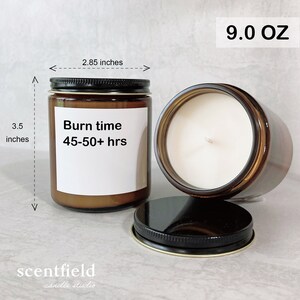 May include: A brown glass candle jar with a white label that reads "Burn time 45-50+ hrs". The candle is 3.5 inches tall and 2.85 inches wide. The candle is 9.0 ounces and has a black lid.