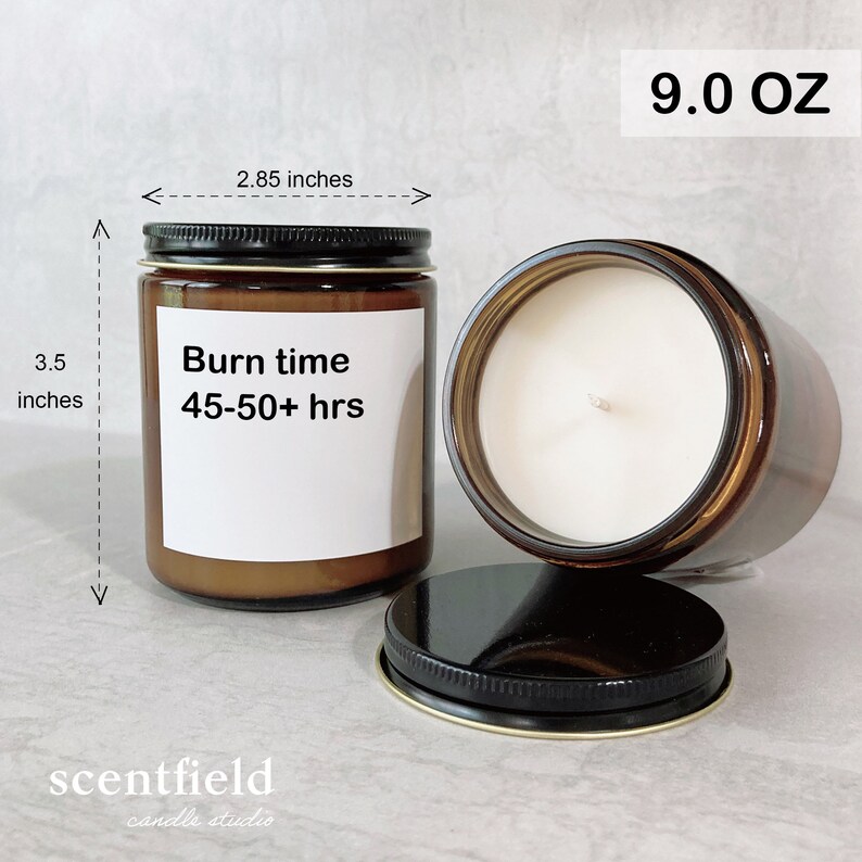 May include: A brown glass candle jar with a white label that reads "Burn time 45-50+ hrs". The candle is 3.5 inches tall and 2.85 inches wide. The candle is 9.0 ounces and has a black lid.