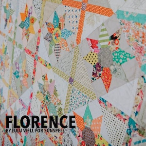 May include: A colourful quilt with a patchwork design featuring a variety of floral and geometric patterns. The quilt is made up of many different fabrics in shades of pink, blue, green, yellow, and orange. The quilt is titled "Florence by Lulu Well for Sunspell".