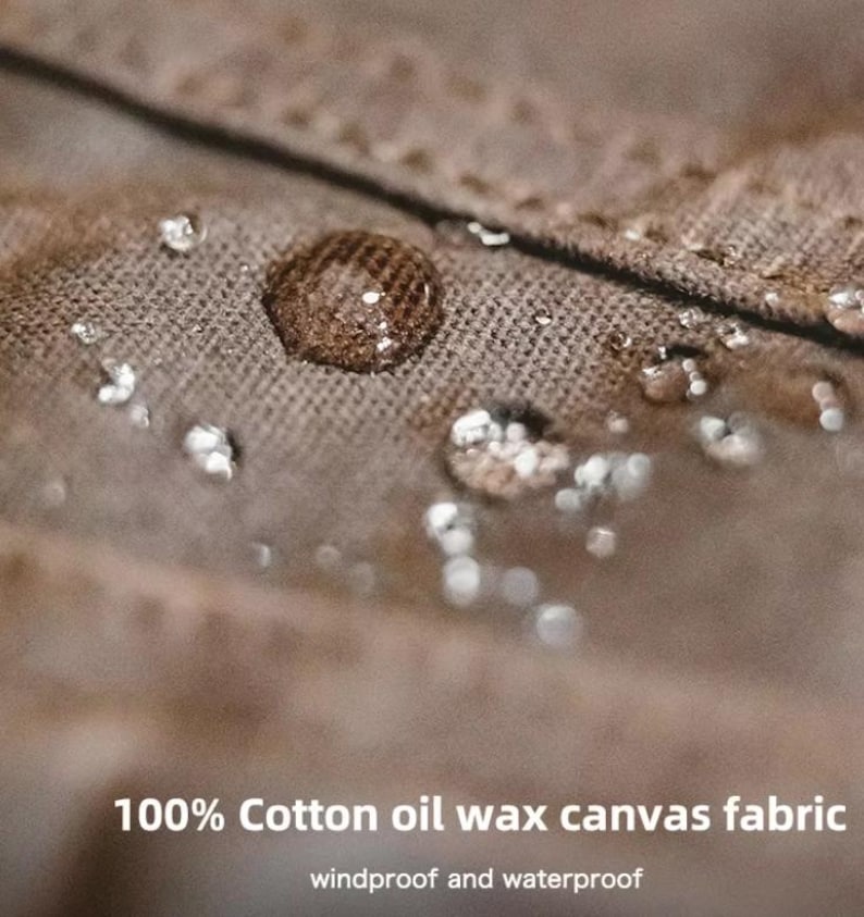 May include: Close-up of a brown cotton oil wax canvas fabric with water droplets. The fabric is windproof and waterproof. The text "100% Cotton oil wax canvas fabric" is visible at the bottom of the image.