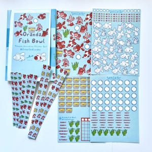 May include: A sticker set featuring illustrations of goldfish in a fish bowl. The set includes a variety of stickers, including goldfish, fish bowls, and other aquatic-themed designs. The stickers are perfect for adding a touch of whimsy to your planner, journal, or scrapbook.