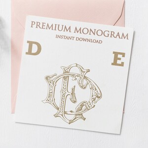 May include: A white card with the text "PREMIUM MONOGRAM INSTANT DOWNLOAD" in black text. The letters "D" and "E" are in gold, and a gold monogram of the letters "D" and "E" is in the center of the card.