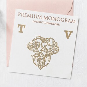 May include: A white card with the text "PREMIUM MONOGRAM INSTANT DOWNLOAD" in gold lettering. The letters "T" and "V" are also in gold lettering. A gold ornate design is in the center of the card.