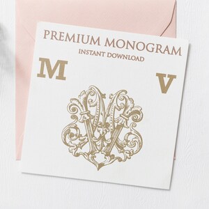 May include: A white card with the text "PREMIUM MONOGRAM INSTANT DOWNLOAD" and the letters "M" and "V" in gold. A gold ornate design with the letters "M" and "V" intertwined is in the center of the card.