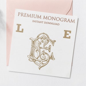 May include: A white card with the text "PREMIUM MONOGRAM INSTANT DOWNLOAD" and the letters "L" and "E" in gold. A gold monogram with the letters "LE" is in the center of the card.