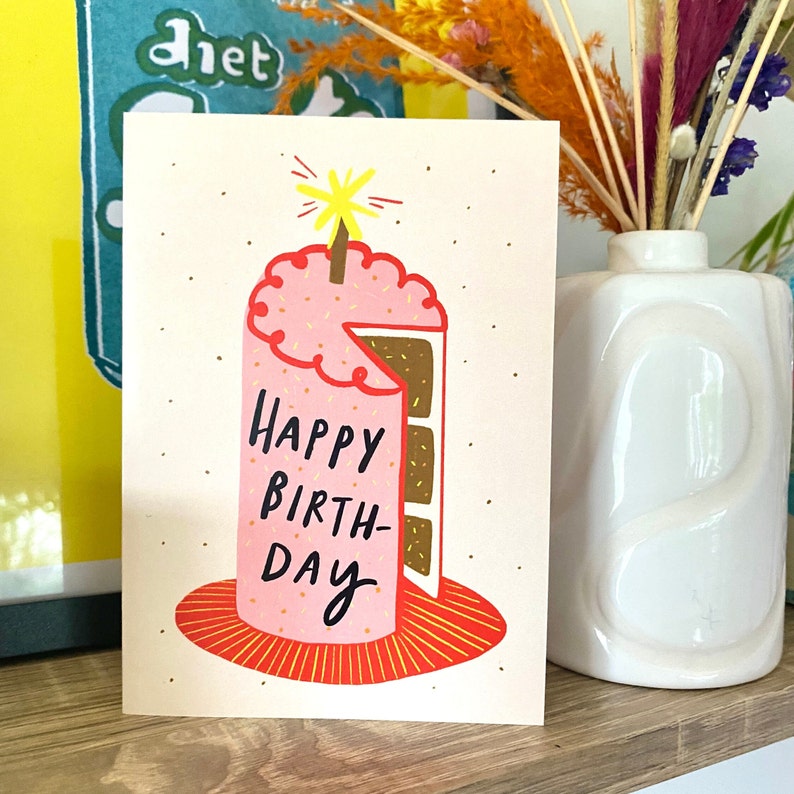 birthday card on shelf, cake says happy birthday