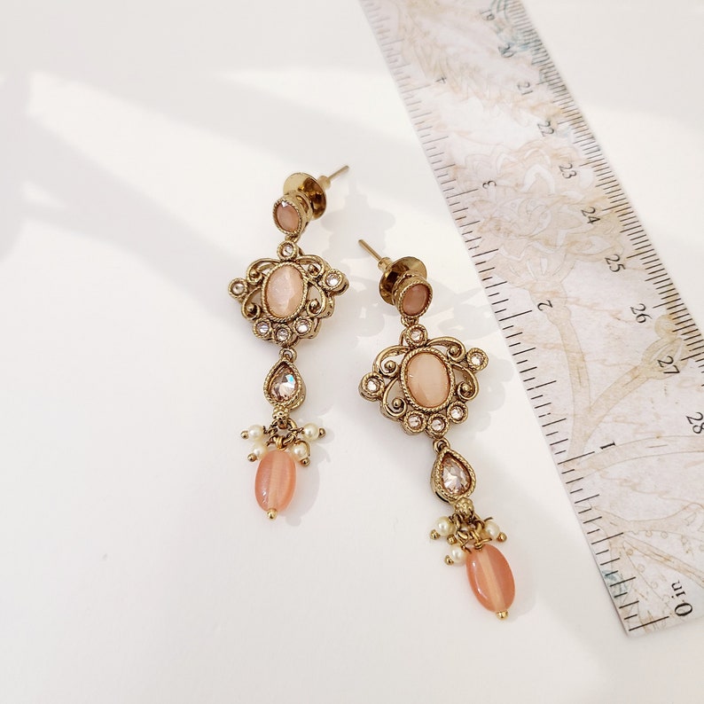 22k Gold plated IndianSouth Asian designed necklace set with gold zircon diamonds and peach accents Comes with matching earrings and tikka
