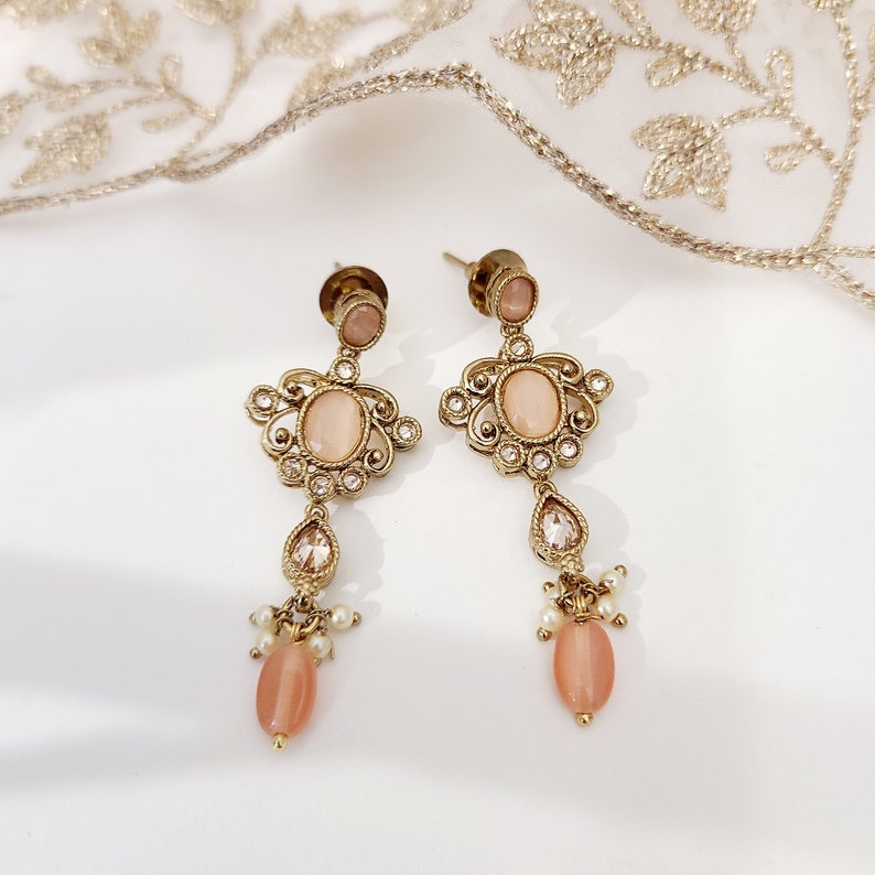 22k Gold plated IndianSouth Asian designed necklace set with gold zircon diamonds and peach accents Comes with matching earrings and tikka