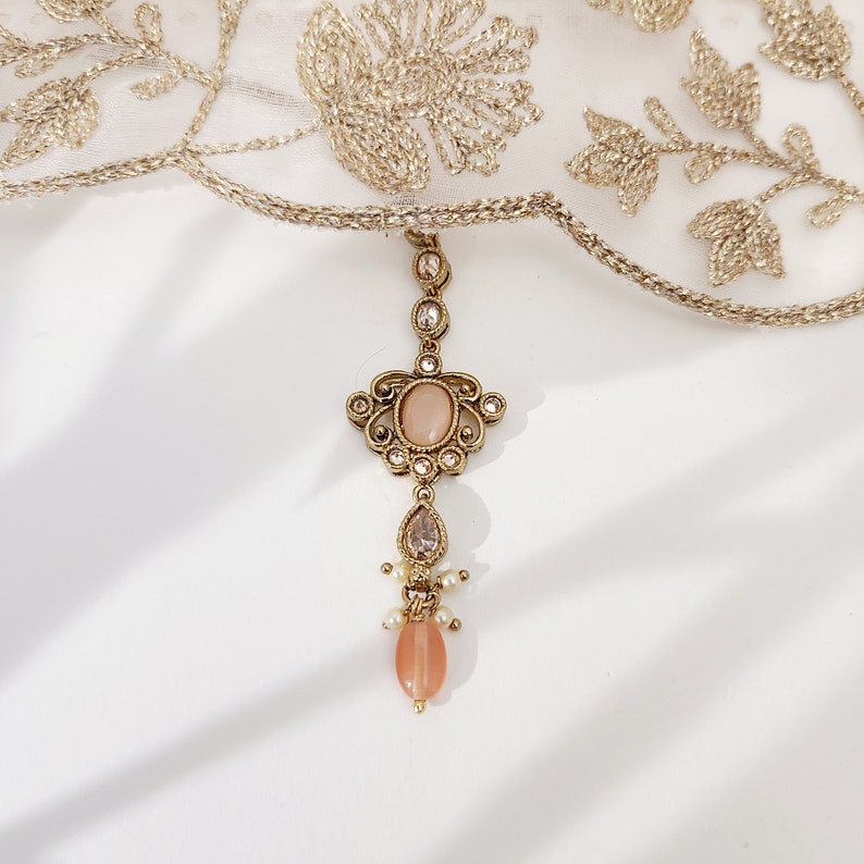 22k Gold plated IndianSouth Asian designed necklace set with gold zircon diamonds and peach accents Comes with matching earrings and tikka