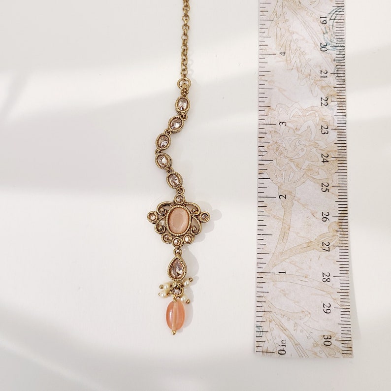 22k Gold plated IndianSouth Asian designed necklace set with gold zircon diamonds and peach accents Comes with matching earrings and tikka