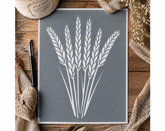 May include: A rectangular print featuring a white graphic illustration of six wheat stalks arranged in a fan shape against a solid slate gray background. The print is presented on a flat surface with a white border framing the central wheat design.
