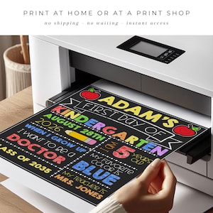 May include: A printed sign on black paper emerging from a white printer. The text reads: ADAM'S FIRST DAY OF KINDERGARTEN AUGUST 28TH 2026, I AM 5 YEARS OLD, WHEN I GROW UP I WANT TO BE A DOCTOR, MY FAVORITE COLOR IS BLUE, CLASS OF 2035, MRS. JONES.