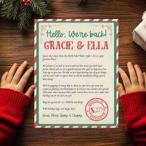 May include: A festive Christmas letter with a red and green border, featuring the text "Hello, We're back! Gracie & Ella." The letter includes a message from elves and a stamped seal. The letter is held by a person wearing a red sweater.