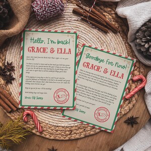 May include: Two Christmas-themed cards with text, "Hello, I'm back!" and "Goodbye For Now!" are displayed on a woven surface. The cards have red and green borders and feature the names "Gracie & Ella." Candy canes and cinnamon sticks are also visible.