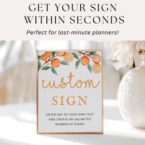 Op de afbeelding: Een gouden bord met een aquarel-illustratie van sinaasappelbloesems en de tekst "custom sign". Het bord bevat ook de tekst "Voer uw eigen tekst in en maak een onbeperkt aantal borden!"