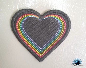May include: A black heart-shaped patch with a rainbow embroidered around the edge. The rainbow is made up of red, orange, yellow, green, blue, indigo, and violet.