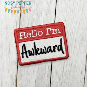 May include: Red and white embroidered iron-on patch with the text "Hello I'm Awkward" in a name tag style.