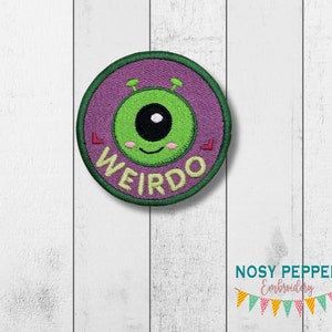 May include: Green alien eye with a purple background and the word "WEIRDO" in yellow letters. The alien has two antennas and a small smile. The patch is circular and has a green border.