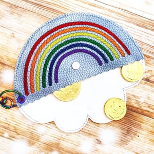 May include: A rainbow-coloured coin purse with a white cloud shape. The purse has a rainbow embroidered on the top half and a white cloud shape on the bottom half. The purse has a gold-coloured zipper and a gold-coloured key chain.