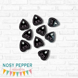 May include: Ten black felt ghost-shaped patches with pink stitching and a white circle in the center. Each patch has the word "Boo" embroidered in pink.