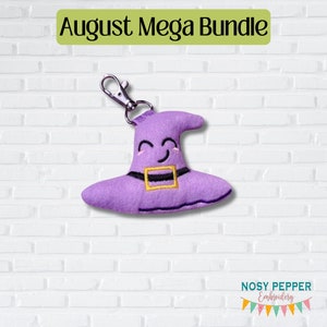 May include: Purple witch hat keychain with a smiling face and a gold buckle. The keychain is hanging from a silver metal ring.