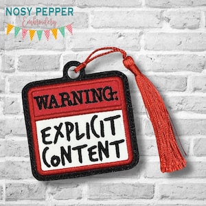 May include: Embroidered tag with the text "WARNING: EXPLICIT CONTENT" in black on a red and white background, with a black border. A red tassel and loop are attached to the tag. The brand "NOSY PEPPER Embroidery" is at the top.