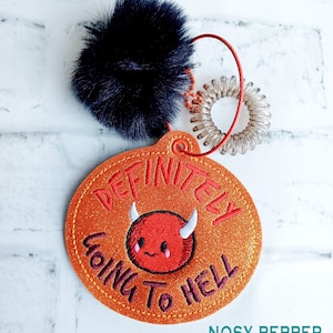 May include: A round orange glitter patch with the text "Definitely Going To Hell" in yellow thread. A red cartoon devil with horns and a smile is in the center of the patch.